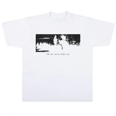 White t-shirt with black graphic image and text reading he has never failed me