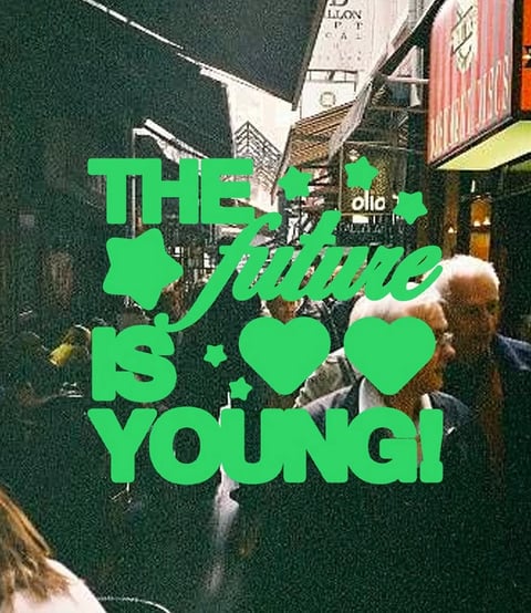 Vibrant green text overlay reading The future is young with hearts on a street scene background with people and storefronts
